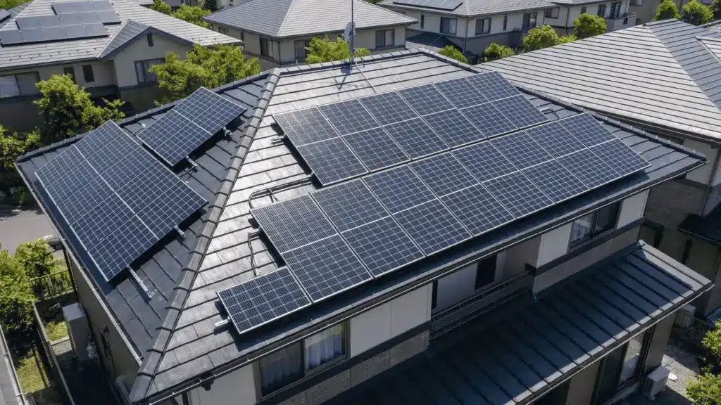 Rooftop solar installation with modern photovoltaic panels arranged in clean rows on a residential house