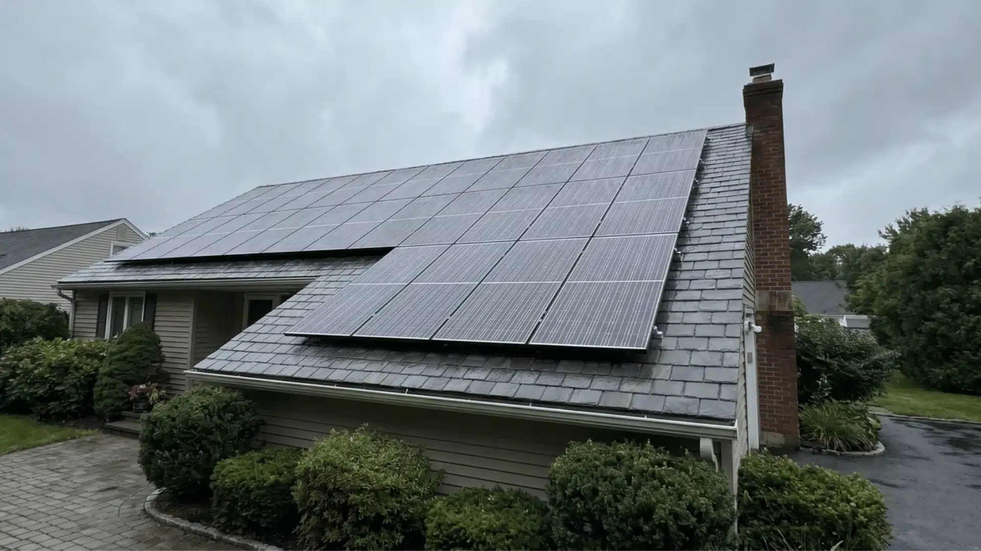 Solar panels on a rooftop under cloudy sky with diffused light