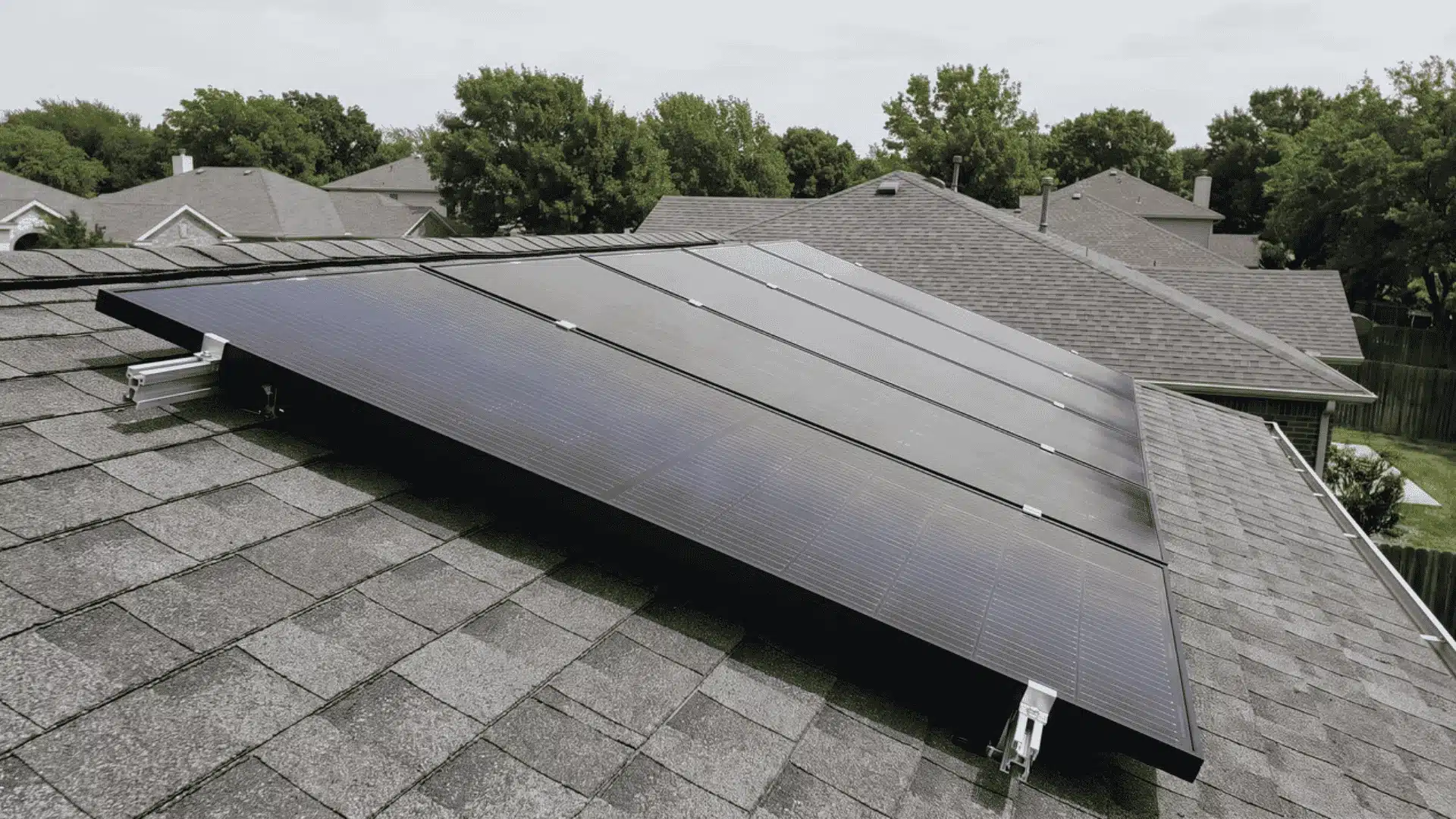 Solar panels mounted on residential roof viewed from angled side perspective