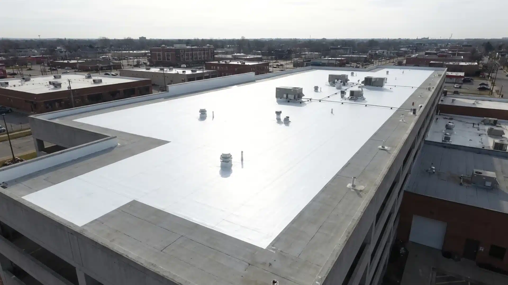 White reflective roof membrane installed on a flat building roof