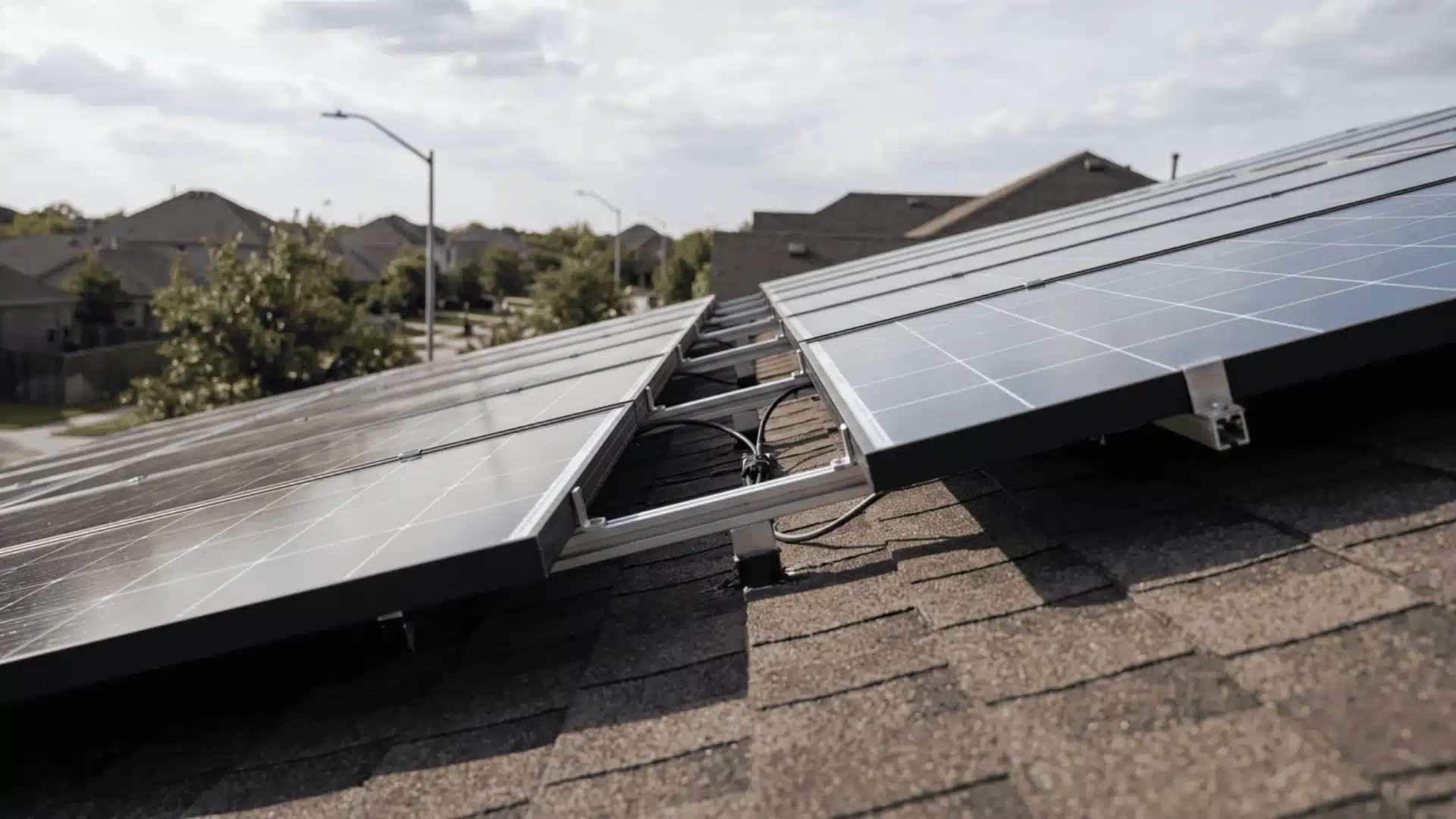 Side view of tilted solar panels mounted on a residential roof.