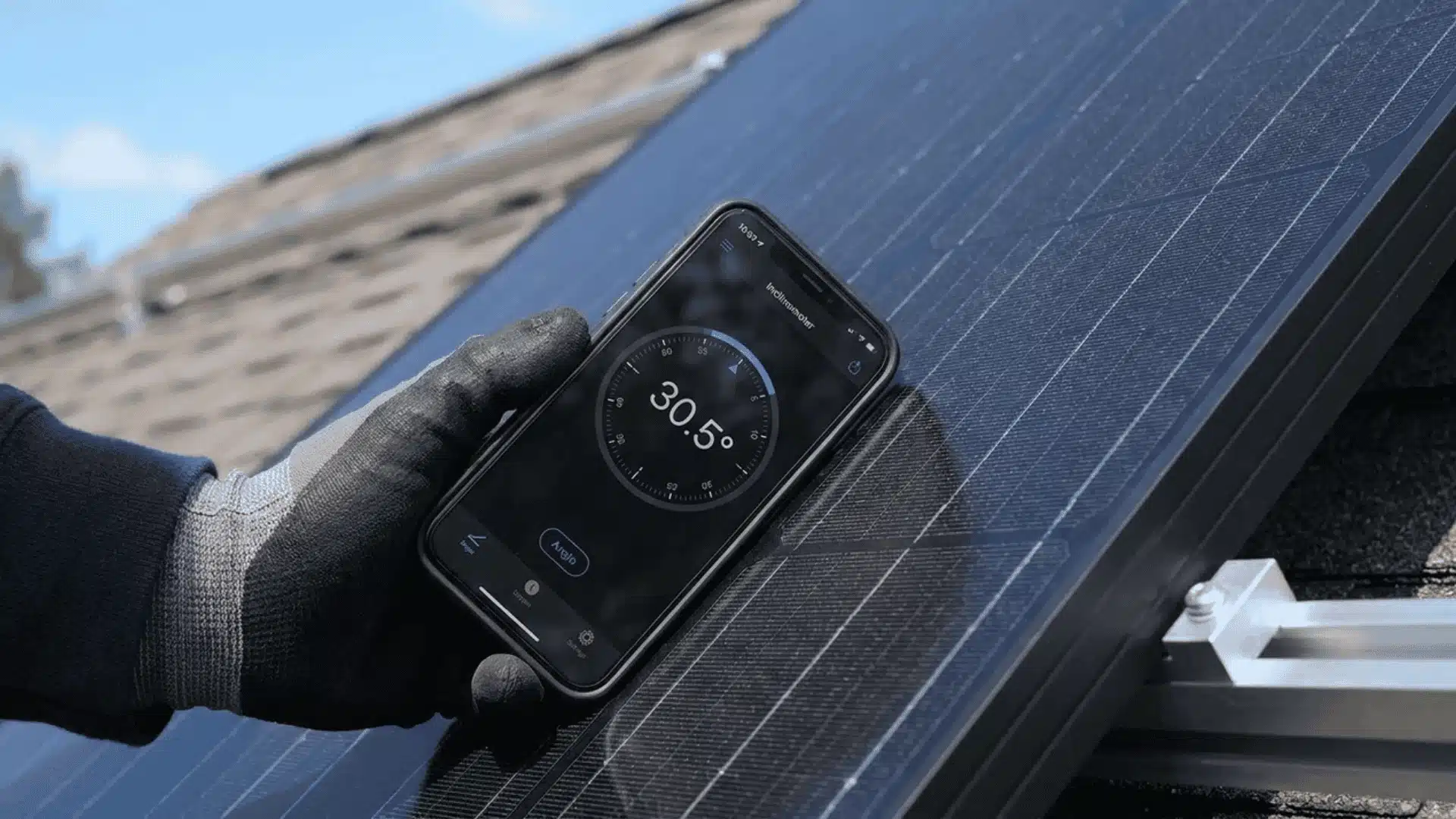 Hand measuring the tilt of a solar panel with a smartphone