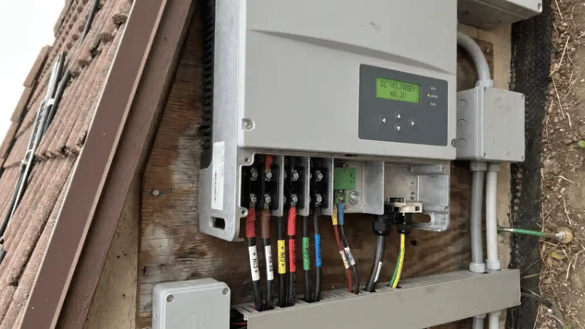 solar inverter connected to multiple solar panel cables with visible terminal connections
