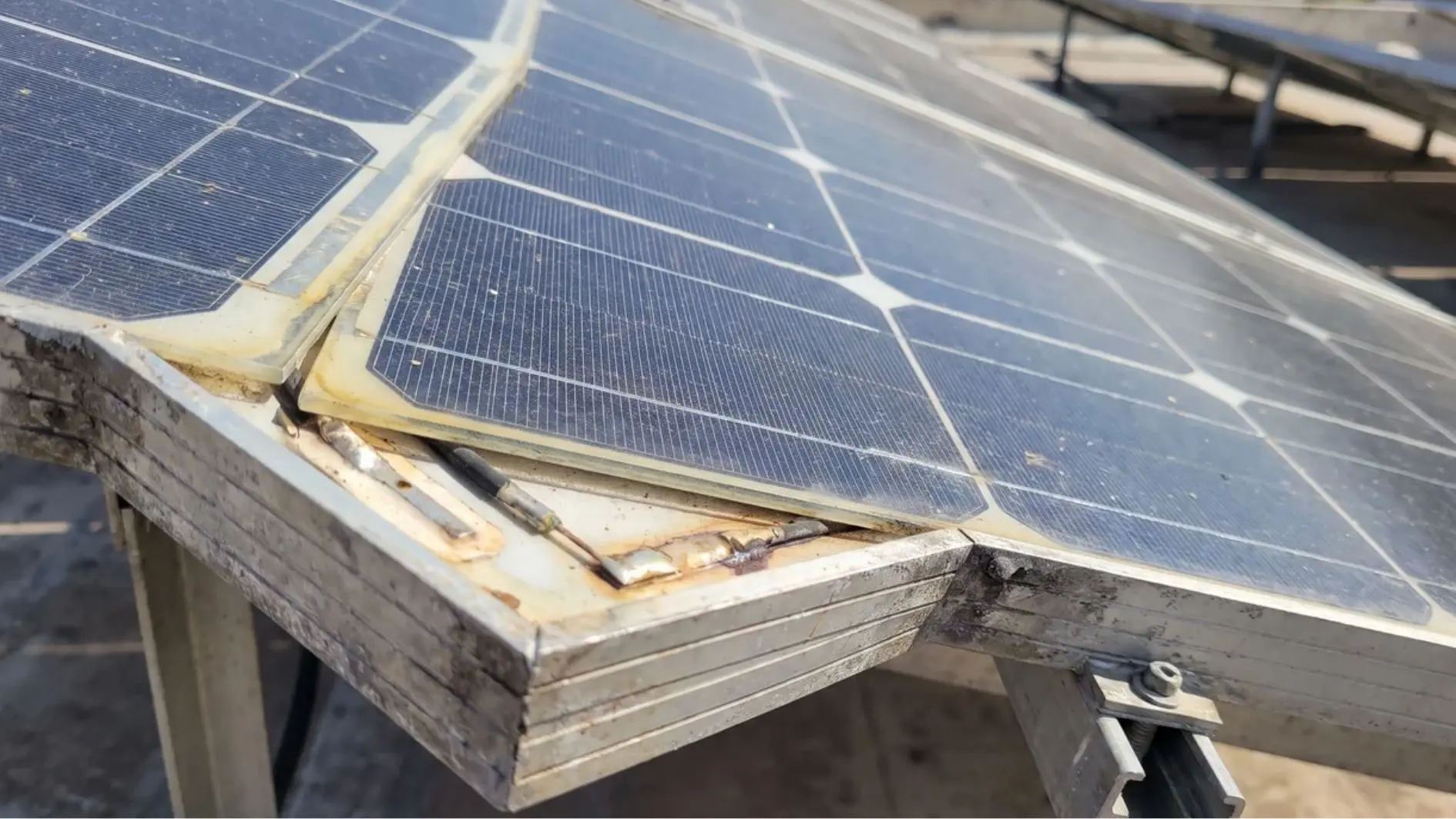 Close-up of solar panel cells, glass surface, and frame layers
