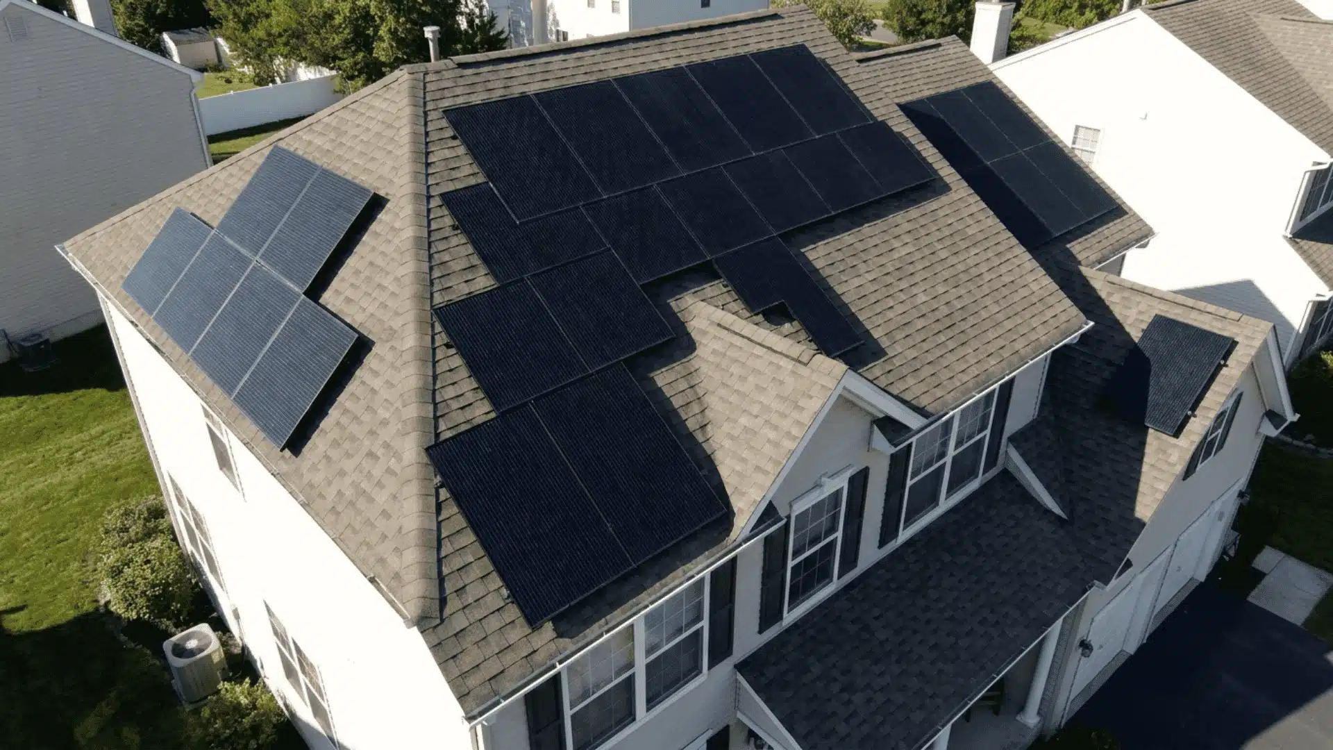 solar panels arranged in sections across different roof surfaces of a house