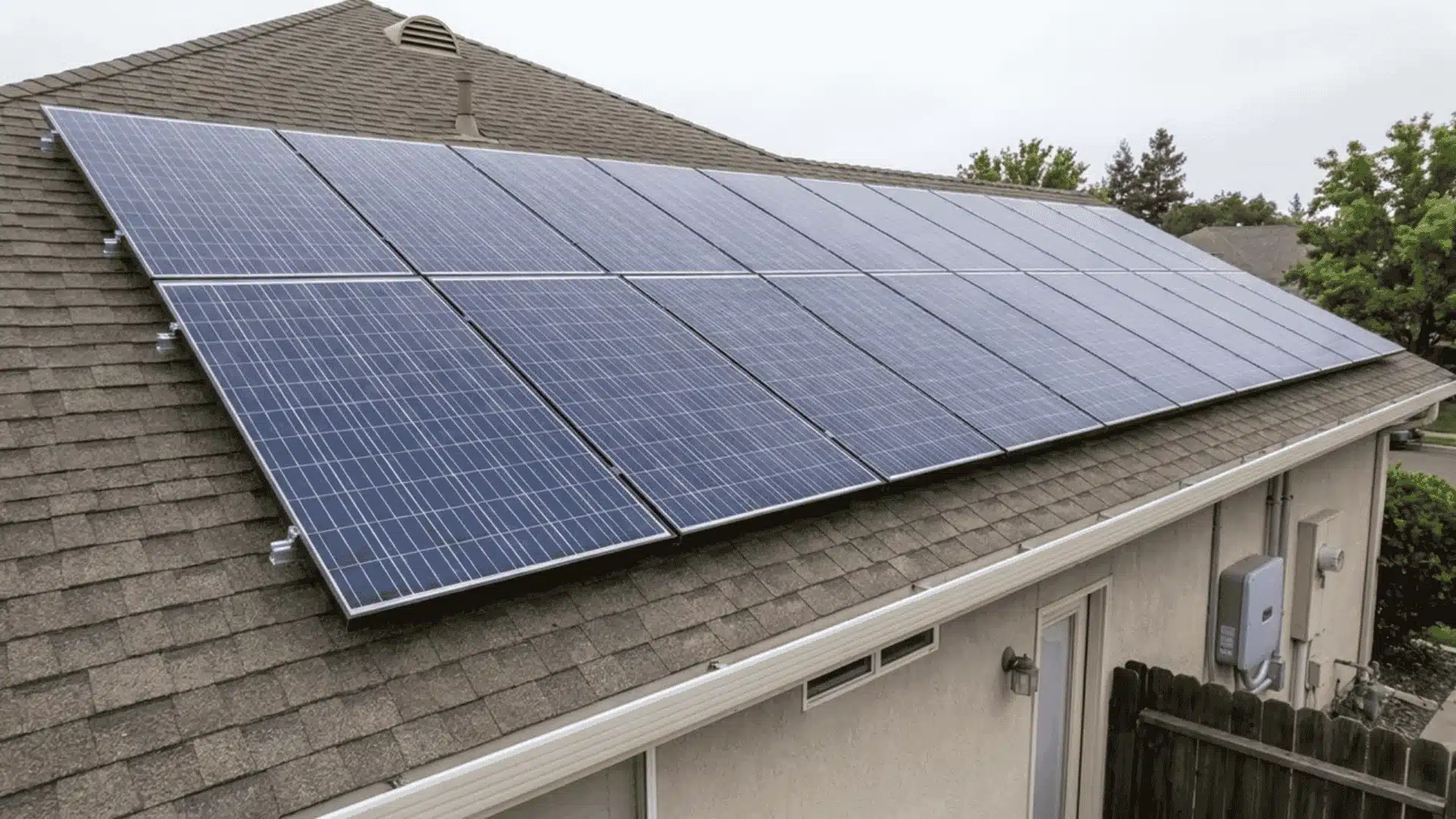 Close view of rooftop solar panels mounted on a shingled house roof