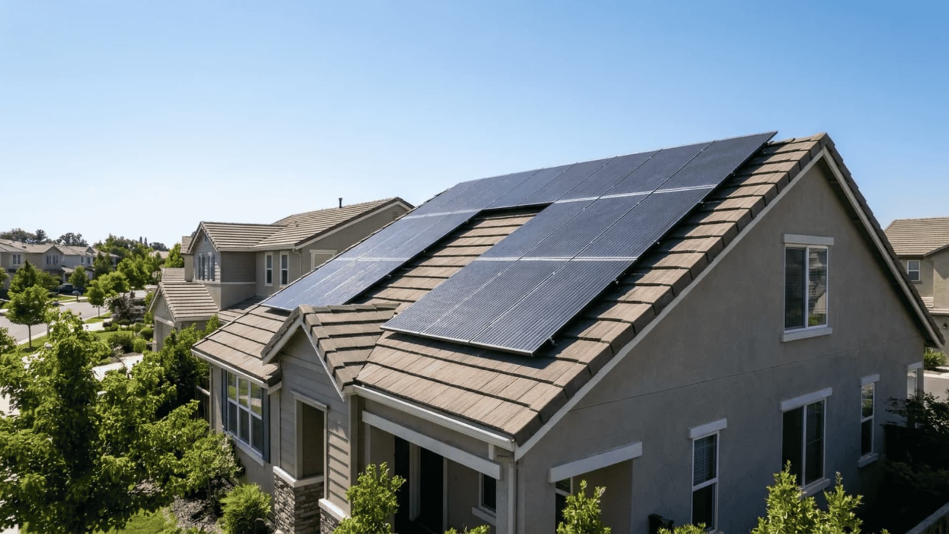 Residential rooftop with angled solar panels under clear daylight