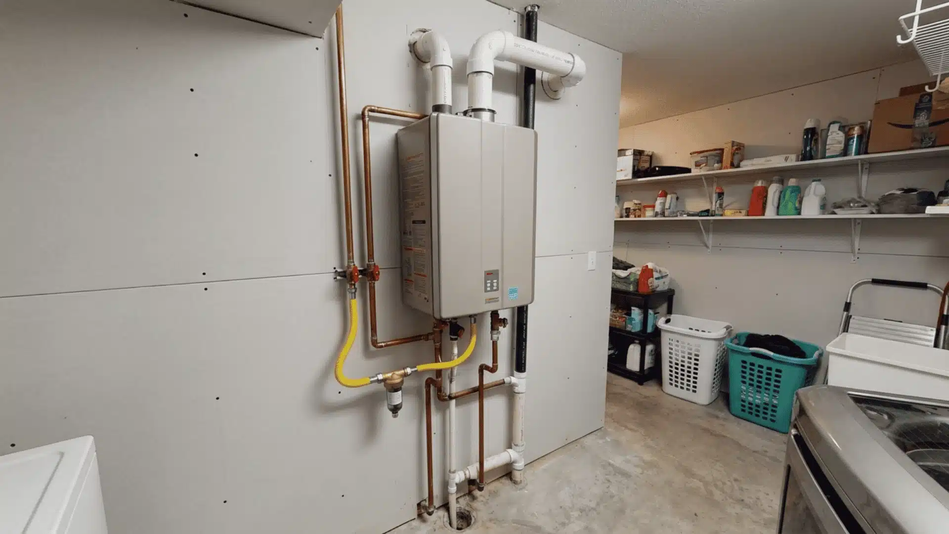 Wall-mounted gas tankless water heater with connected pipes and venting in a utility room