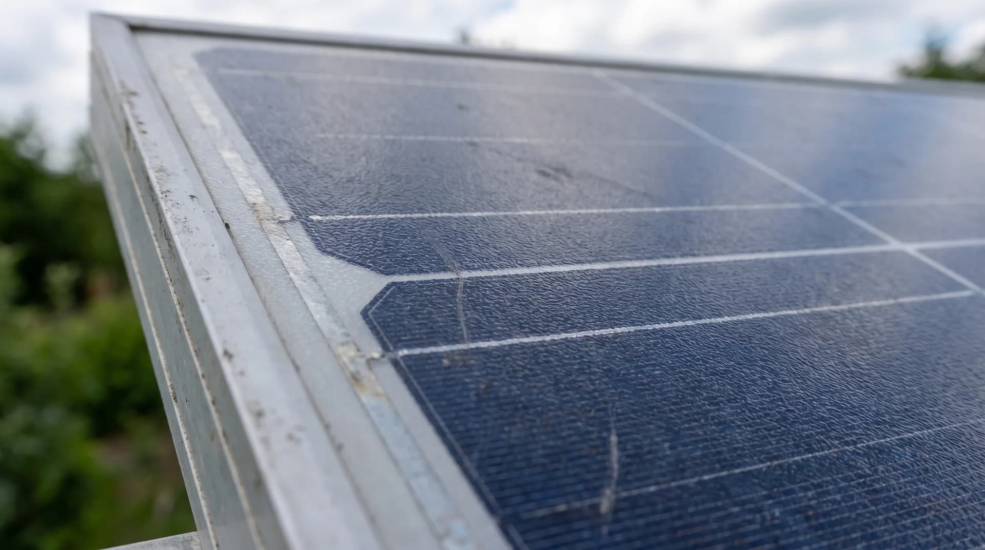 Close-up of an intact solar panel surface with tempered glass and aluminum frame edge