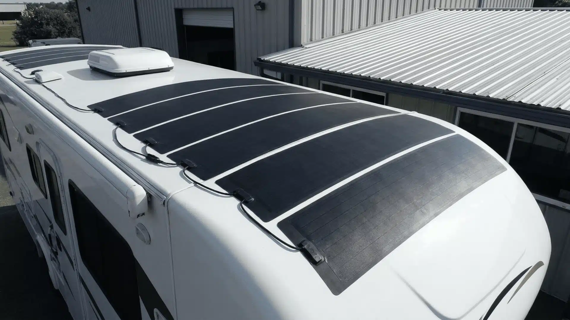 Flexible thin-film solar panels fitted to a curved RV roof