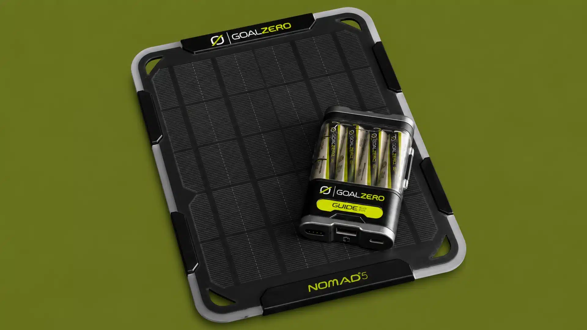 Goal Zero Nomad 5 solar panel and Guide 12 charger displayed beside a rocky forest stream